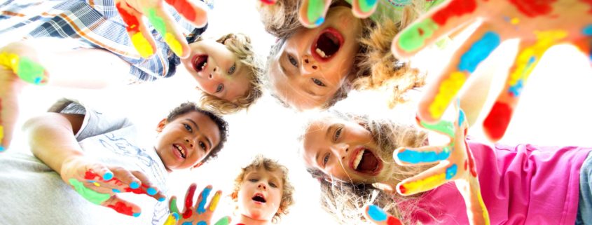 smiling kids with colourfull hands